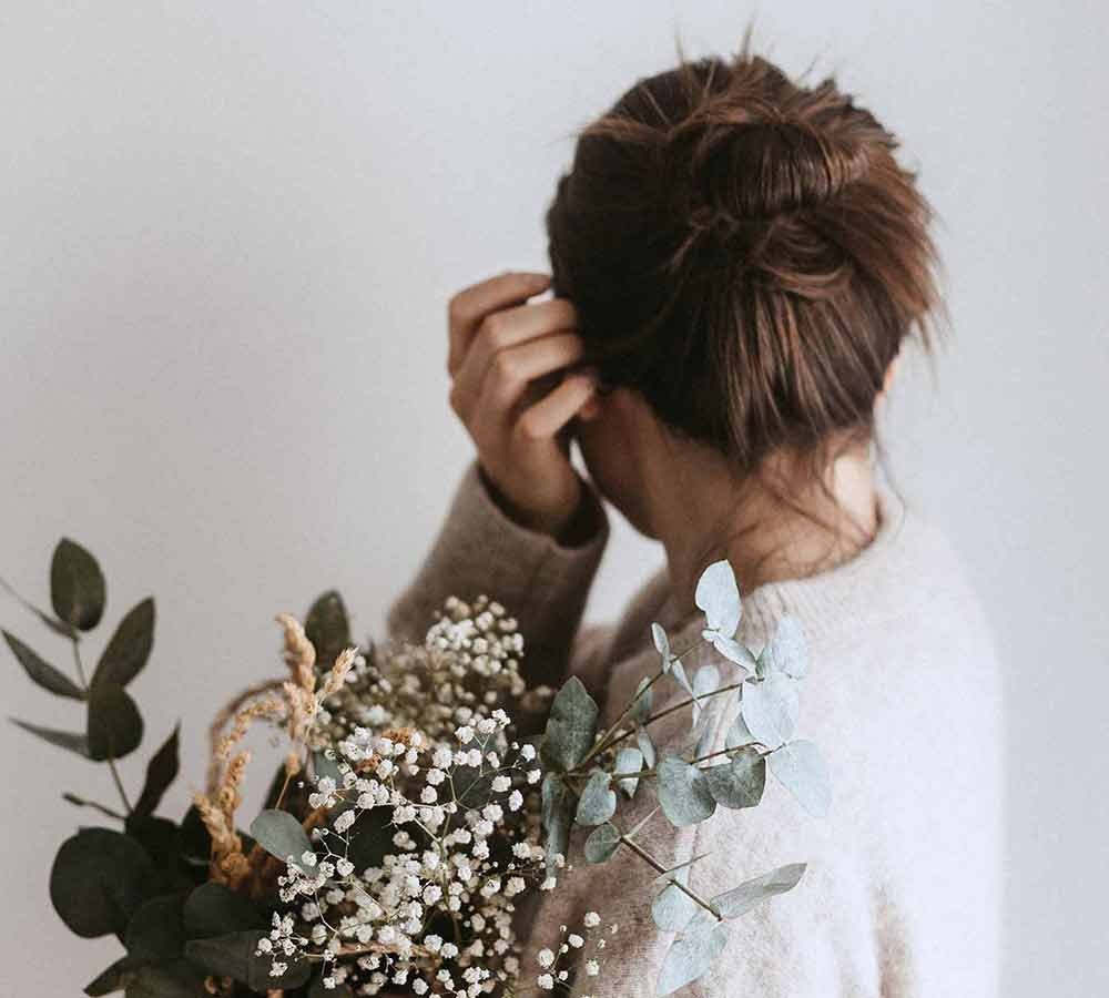 Woman Tucking Her Hair Behind Her Ear